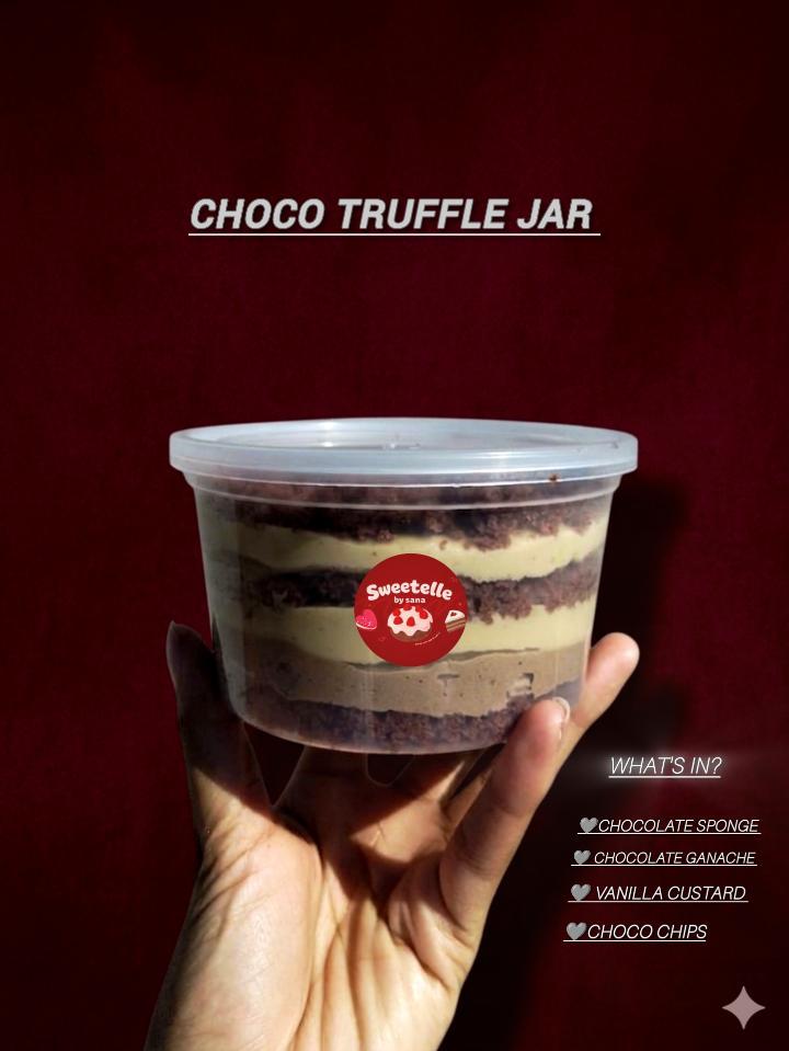 Layered chocolate truffle jar held against a red background