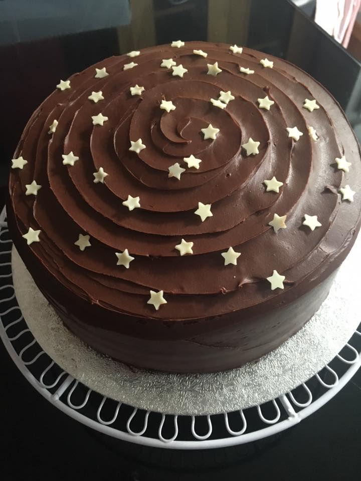 Chocolate celebration cake decorated with golden stars